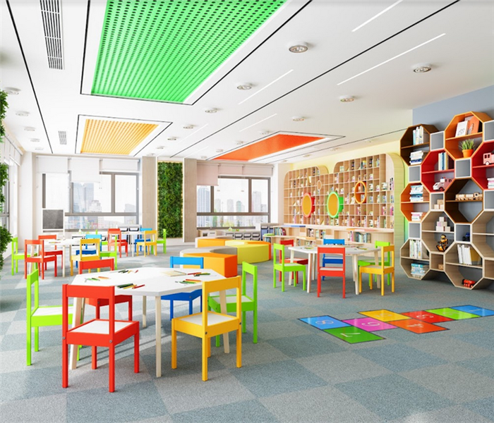 a daycare facility with chairs and tables and books everywhere